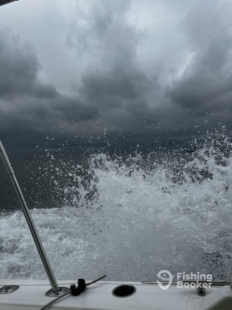 A dynamic shot capturing the splashing water from the boat's wake under a cloudy sky, suggesting an adventurous day on the water.