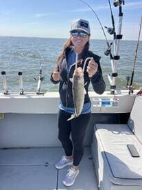 Angler proudly displaying a large fish while enjoying a day on the water, showcasing the excitement of a successful fishing trip.